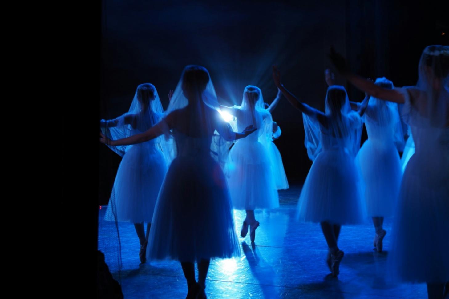 Student practicing choreography in dance studio environment