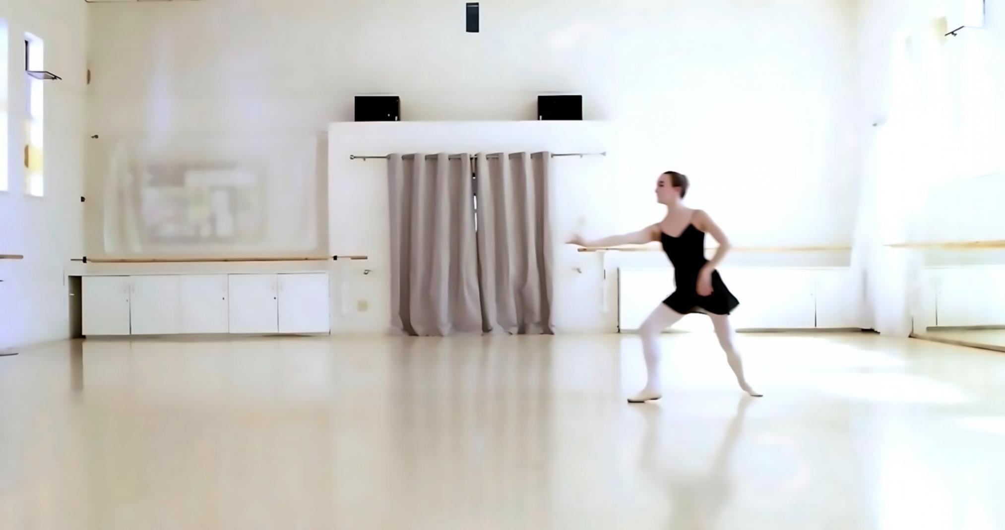 Dance instructor teaching beginner student movement basics in studio